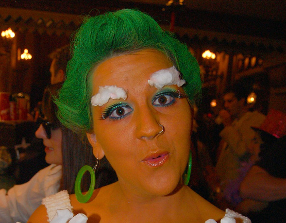 women with Oompa Loompa makeup (orange face, green hair)