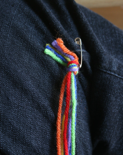 yarn safety pinned to a pair of jeans 