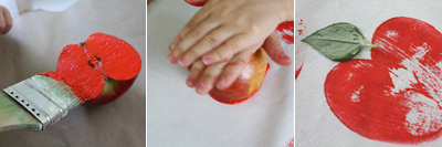 Apple printing onto fabric with red paint 