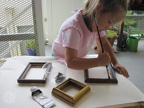 a child painting old frames 