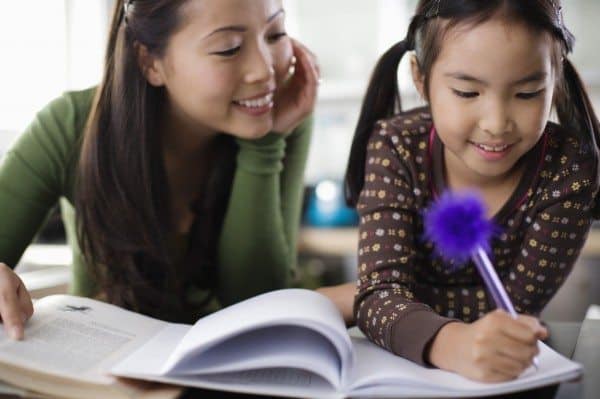 A mother helping her daughter with homework