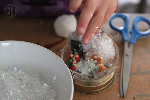 Filling the base of a Waterless Snow Globes