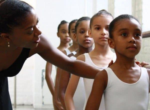 young DTH ballet students at the barre with a teacher correcting