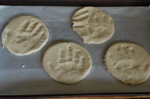 Hand prints on circle dough shapes on paper