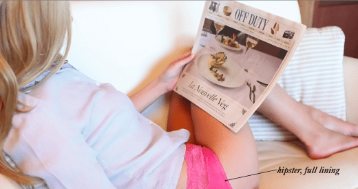 picture of a woman wearing undies and reading the paper