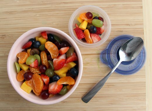 two bowls filled with rainbow colored fruit