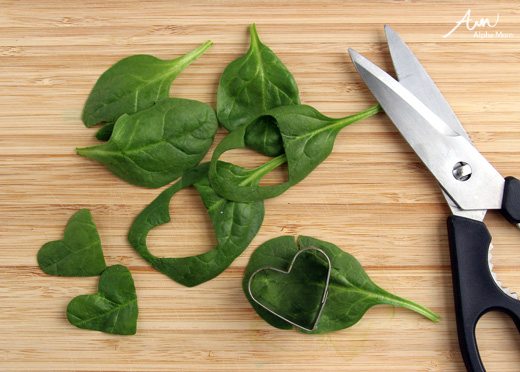 spinach cut with scissors on a cutting board