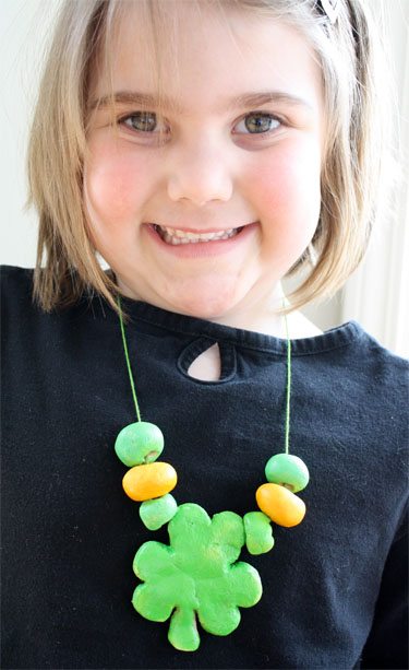 photo of blond girl wearing a handmade shamrock necklace made from salt dough