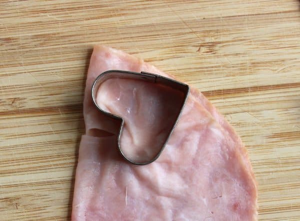 Cutting heart shaped ham with cookie cutter 