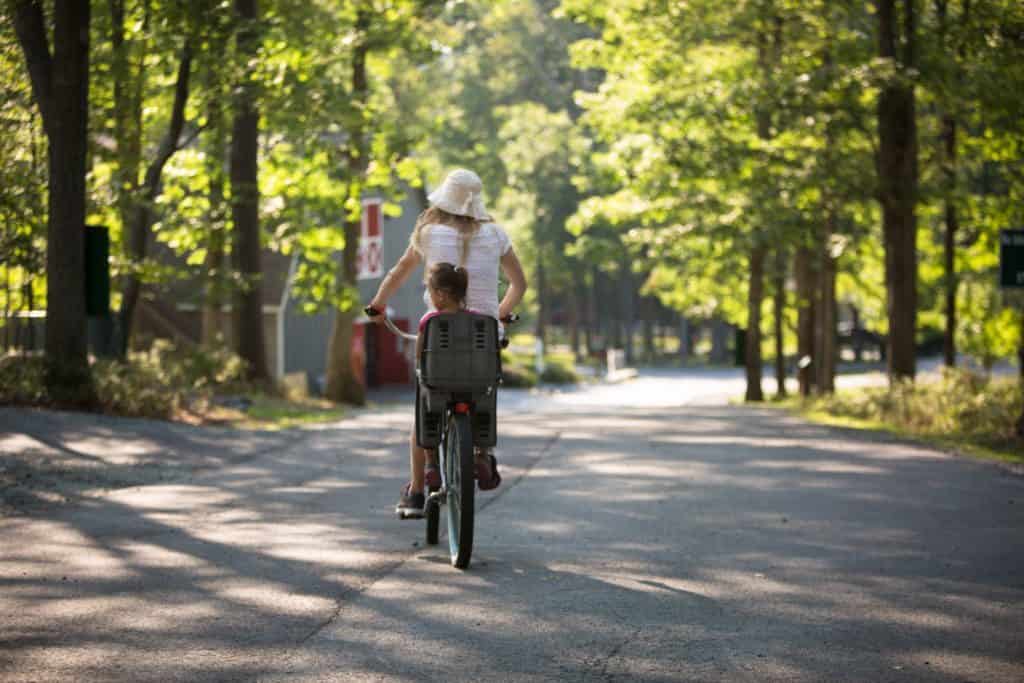 A parent and a child riding a bike 