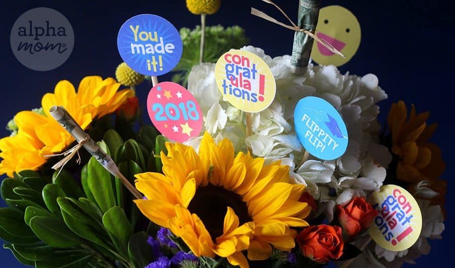 close-up photo of Graduation Flower Bouquet with messages and money on sticks tucked into the flowers