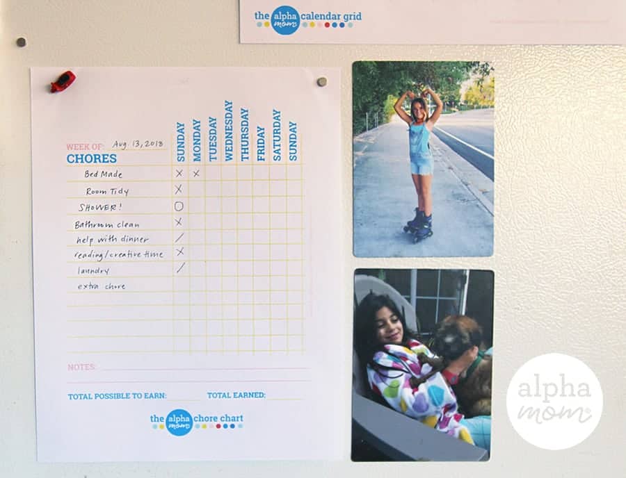 Weekly family chore chart printable stuck on a refrigerator next to two family photos 