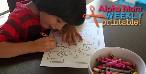young boy drawing and coloring a Ramadan craft sheet