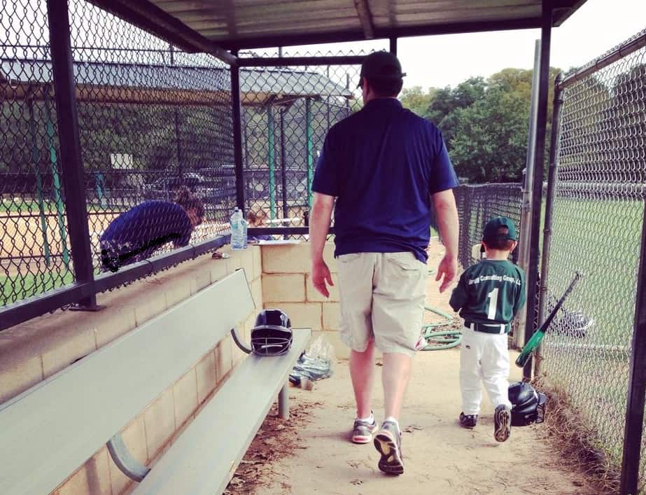 photo of father and young son in baseball dugout