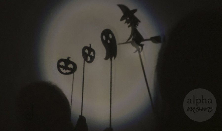 puppet shadow images of witch, ghost, and two pumpkins on sticks