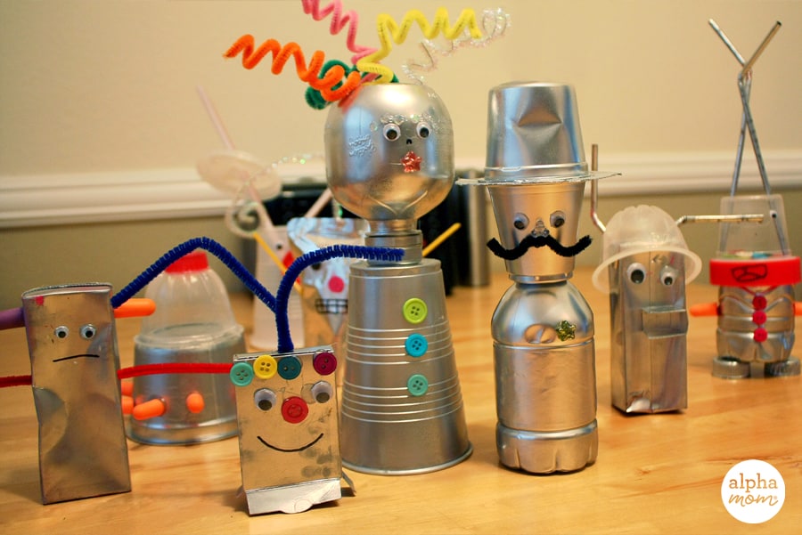 nine handmade toys that look like robots painted in silver from upcycled lunchbox recyclables