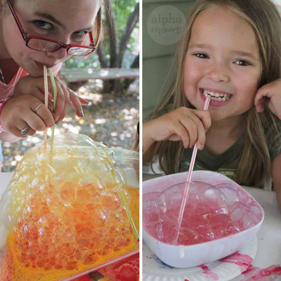 two photos of young girls blowing soap paint bubbles through straws. one is blowing orange bubbles and the other is blowing pink ones.